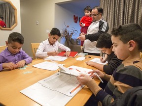 Syrian family of Raed Aljamous with his children Mohammad, Alyaman, Laith, Yesen and daughter Yamama working on homework in their kitchen of their westside home in Montgomery, arrived in Canada a year ago and are adjusting in Saskatoon quite well, December 12, 2016.