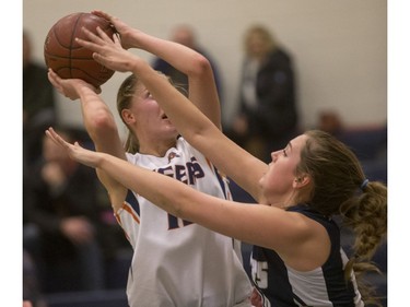 The height of Tommy Douglas Tigers' Sydney Tabin and her lay up out-matches the Bethlehem Stars' shorter defenders in girls high school basketball league play, December 13, 2016.