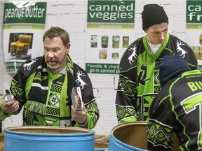 Rush president Lee Genier (left) wore his ugly Christmas sweater jersey at the Saskatoon Food Bank Thursday, along with players Brett Mydske and Nik Bilic.