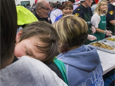 A sleepy little guy misses volunteers serving up hundreds at the Saskatoon Tribal Council's annual Community Christmas Celebration at the White Buffalo Youth Lodge where hundreds of community members join the celebration with a hot turkey dinner and a special visit from Santa Claus for families in need, December 15, 2016.