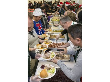 Volunteers serve up hundreds at the Saskatoon Tribal Council's annual Community Christmas Celebration at the White Buffalo Youth Lodge where hundreds of community members join the celebration with a hot turkey dinner and a special visit from Santa Claus for families in need, December 15, 2016.