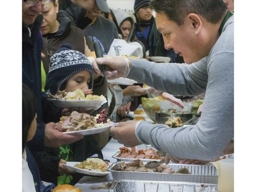 Volunteers serve up hundreds at the Saskatoon Tribal Council's annual Community Christmas Celebration at the White Buffalo Youth Lodge where hundreds of community members join the celebration with a hot turkey dinner and a special visit from Santa Claus for families in need, December 15, 2016.