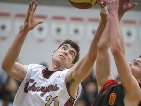 Centennial Chargers # 21 Jordan Silzer battles for the rebound against Moose Jaw Central Cyclones #8 Kyle Boughen in a after noon High School Basketball Charity game in the first game of a tournament that will see proceeds go to the Children's Hospital Foundation, Christmas Hamper Project, December 9, 2016