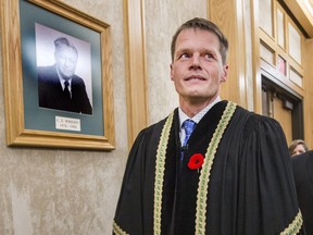 Saskatoon's new mayor Charlie Clark is ushered in to bag pipe music and applause during the Arrival of the Official Party of the newly elected mayor and city councillors before being sworn in, October 31, 2016.