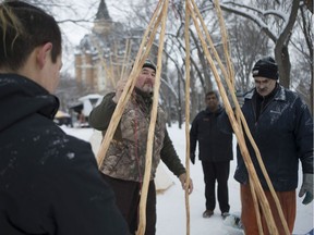 Karl Stewart, far right, assists in the building of a Teepee for the Canada 150 Celebration in Saskatoon, Sask. on Dec. 31, 2016. (Kayle Neis/Saskatoon StarPhoenix)