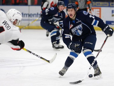 Saskatoon Blades' Michael Farren blocks a shot from Moose Jaw Warriors' Jett Woo during the first half of their game at SaskTel Centre in Saskatoon on December 11, 2016.