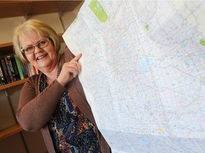Rose Olfert, professor emerita at the University of Saskatchewan's Johnson Shoyama Graduate School of Public Policy, who has written extensively on rural municipalities in the province of Saskatchewan, holds up a map of the grid roads, which have the rural municipalities numbered throughout in Saskatoon on December 12, 2016.