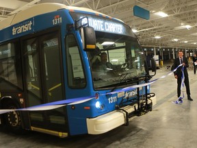 SASKATOON, SK - December 13, 2016 -  Mayor Charlie Clark holds a ribbon as a Saskatoon Transit bus drives through it marking the official ribbon cutting of the new Civic Operations Centre in Saskatoon on December 13, 2016. (Michelle Berg / Saskatoon StarPhoenix)