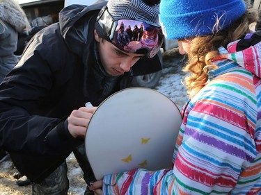 Olympic medalist Mark McMorris signs an autograph for Stevie Robinson at Diefenbaker Park in Saskatoon on December 21, 2016.