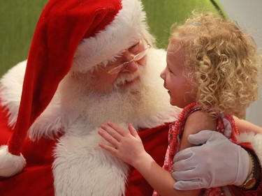 Three-and-a-half year old Mya Redl gets her Christmas gift request to Santa just in the nick of time at Lawson Heights Mall in Saskatoon on December 22, 2016.