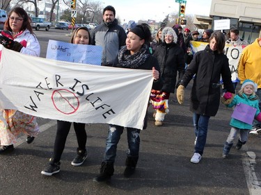 L-R: Cheryl Taniskishayinew, Jersey Machiskinic and Amanda Peequaquat walked in a group of 35 people from Midtown Plaza to the bottom of the Broadway Bridge during a Standing Rock solidarity protest in Saskatoon on December 4, 2016.