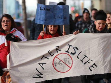 L-R: Cheryl Taniskishayinew, Jersey Machiskinic and Amanda Peequaquat walked in a group of 35 people from Midtown Plaza to the bottom of the Broadway Bridge during a Standing Rock solidarity protest in Saskatoon on December 4, 2016.