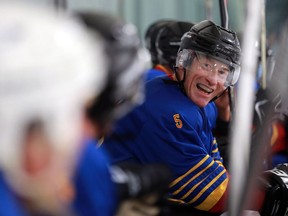 SASKATOON, SK - December 4, 2016 - Deja Blue's Kieron Kilduff smiles on the bench during a game against the Leafs in the over 50 hockey tournament at Schroh Arena in Saskatoon on December 4, 2016. (Michelle Berg / Saskatoon StarPhoenix)