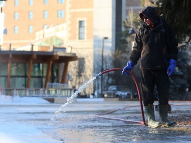 Devin Ostlund fills up the Meewasin skating rink on Spading Crescent during a bitterly cold morning in Saskatoon on December 4, 2016.