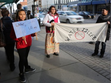 L-R: Jersey Machiskinic, Cheryl Taniskishayinew and Amanda Peequaquat walked in a group of 35 people from Midtown Plaza to the bottom of the Broadway Bridge during a Standing Rock solidarity protest in Saskatoon on December 4, 2016.