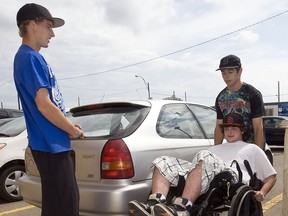 Ryan White, who was shot during a robbery, leaves provincial court Monday, August 15, 2011 with help from friends Mike Epp, left, and Chris Cameron.