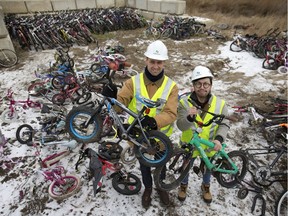 Patrick Schmidt, project engineer of water and waste stream division at the Saskatoon landfill, and Stan Yu from the Bridge City Bike Co-op stand among hundreds of unwanted bikes at the landfill that will be repurposed by the Bridge City Bike Co-op.
