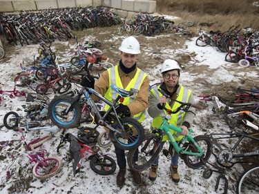 Patrick Schmidt, project engineer, water and waste stream division at the Saskatoon landfill (L), and Stan Yu from the Bridge City Bike Co-op pose December 1, 2016 amongst hundreds of unwanted bikes that end up at the Saskatoon landfill which are now being given a second chance to ride the roads.