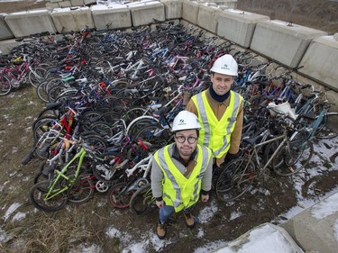 Patrick Schmidt, project engineer, water and waste stream division at the Saskatoon landfill (R), and Stan Yu from the Bridge City Bike Co-op pose December 1, 2016 amongst hundreds of unwanted bikes that end up at the Saskatoon landfill which are now being given a second chance to ride the roads.