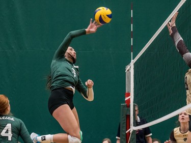 University of Saskatchewan Huskies women's volleyball middle blocker #3 Marguerite Ferguson hits the ball against the University of Manitoba Bisons during CIS Women's Volleyball action in Saskatoon, December 3, 2016.