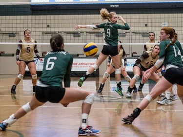 University of Saskatchewan Huskies women's volleyball middle blocker #9 Emily Humbert looks back as outside hitter #6 Emmalyn Copping lines up to hit the ball against the University of Manitoba Bisons during CIS Women's Volley ball action in Saskatoon, December 3, 2016.