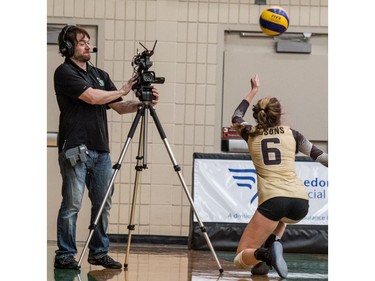 University of Manitoba Bisons' #6 Sydney Booker has a close call with a cameraman against the University of Saskatchewan Huskies  during CIS Women's volleyball action in Saskatoon, December 3, 2016.