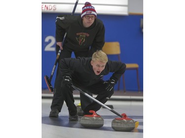 Holy Cross Crusaders' Caid Brossart (front) calls the shot as Centennial Chargers skip Jake Scriven watches during high school curling action at the CN Curling Club, December 6, 2016.
