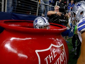 Ezekiel Elliott peers out of a Salvation Army kettle after a Sunday touchdown in Texas.
