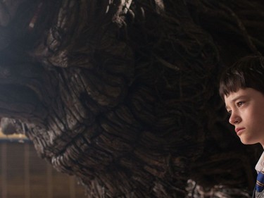 Lewis MacDougall appears with The Monster, voiced by Liam Neeson, in "A Monster Calls."