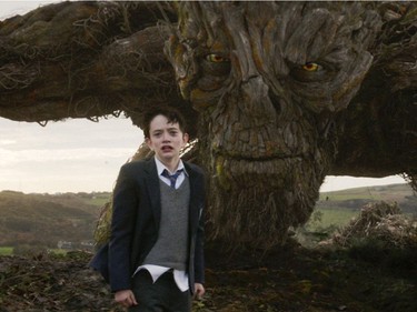 Lewis MacDougall appears with The Monster, voiced by Liam Neeson, in "A Monster Calls."