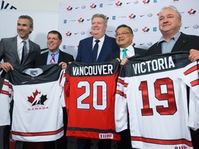 Vancouver Canucks' President of Hockey Operations Trevor Linden, from left to right, Hockey Canada COO Scott Smith, B.C. Deputy Premier Rich Coleman, Vancouver City Councillor Raymond Louie, and host committee co-chair Ron Toigo, pose for photographs after announcing the 2019 World Junior Hockey Championship will be held in Vancouver and Victoria, during a news conference in Vancouver, B.C., on Thursday December 1, 2016.