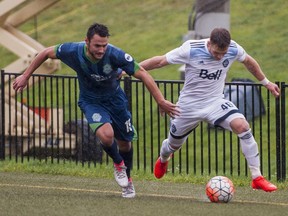 Vancouver Whitecaps  Brett Levis (46) tries to break free from tOKC Energy FC Timo Pitter during USL playoff soccer action at Thunderbird Stadium at UBC in Vancouver, BC, October, 8, 2016.