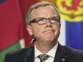 Saskatchewan Premier Brad Wall listens to a speaker during the closing news conference at the First Ministers Meeting in Ottawa, Friday December 9, 2016. THE CANADIAN PRESS/Adrian Wyld