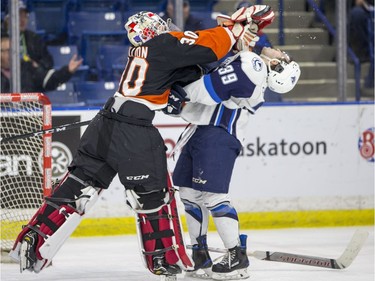 Medicine Hat Tigers goalie Michael Bullion hits Saskatoon Blades forward Caleb Fantillo during the first period of WHL action in Saskatoon, January 18, 2017. Bullion got a two minute roughing penalty and the Blades scored on the power play.