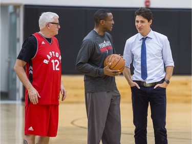 Canadian Prime Minister Justin Trudeau chats with Toronto Raptors head coach Dwane Casey and Greg Hatch (left), interim principal with visiting students of La Loche Community School in Saskatchewan on the basketball court at the BioSteel Centre, where the Toronto Raptors practice, in Toronto, Ont. on Friday January 13, 2017.  Masai Ujiri, Toronto Raptors president and general manager, hosted a group of 10 kids, plus two teachers, from La Loche, Saskatchewan. Ernest Doroszuk/Toronto Sun/Postmedia Network