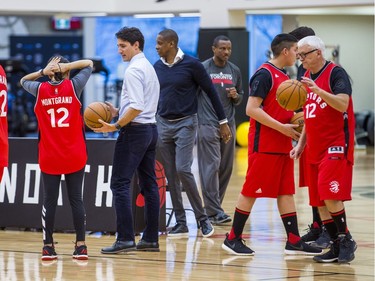 Canadian Prime Minister Justin Trudeau (from front, middle), Toronto Raptors president and general manager Masai Ujiri and Raptor head coach Dwane Casey with visiting students of La Loche Community School in Saskatchewan on the basketball court at the BioSteel Centre, where the Toronto Raptors practice, in Toronto, Ont. on Friday January 13, 2017.  Masai Ujiri, Toronto Raptors president and general manager, hosted a group of 10 kids, plus two teachers, from La Loche, Saskatchewan. Ernest Doroszuk/Toronto Sun/Postmedia Network
