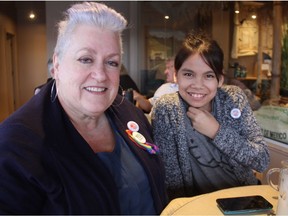 Fran Forsberg and her child Tana, 12, who is two-spirited and identifies with neither gender, wear equal-right buttons and ribbons as they enjoy a beverage at the Broadway Roastery on 8th Street in Saskatoon on Jan. 30, 2017. Forsberg is hopeful the Government of Saskatchewan will pay close attention to a recent settlement between the Canadian Human Rights Commission and Employment and Social Development Canada on gender identity.