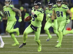 Seattle Seahawks punter Jon Ryan (9) runs the ball after a fake punt against the Los Angeles Rams in the second half of an NFL football game, Thursday, Dec. 15, 2016, in Seattle. Ryan suffered an injury on the play and left the game.