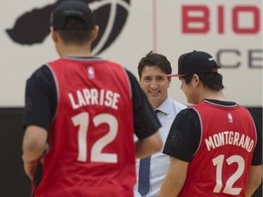 Prime Minister Justin Trudeau watches players Braden Laprise, and Preston Montgrand, from La Loche, Sask., practice at the Toronto Raptors practice facility in Toronto on Friday, January 13, 2017.