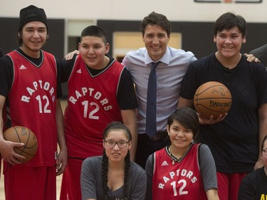 Prime Minister Justin Trudeau, Toronto Raptors coach Dwane Casey and players from La Loche, Sask., pose for group photo following practice at the Toronto Raptors practice facility in Toronto on Friday, January 13, 2017.