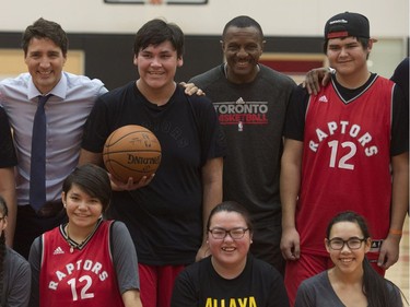 Prime Minister Justin Trudeau, Toronto Raptors coach Dwane Casey and players from La Loche, Sask., pose for group photo following practice at the Toronto Raptors practice facility in Toronto on Friday, January 13, 2017.