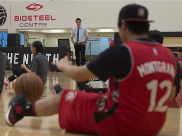 Prime Minister Justin Trudeau watches players from La Loche, Sask., do drills during a practice at the Toronto Raptors practice facility in Toronto on Friday, January 13, 2017.