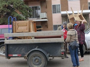 Members of the P.O.R.C.H sponsorship group loading up furniture destined for the future home of a refugee family.