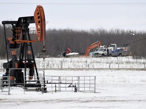 Crews work to clean up an oil spill on Ocean Man First Nation about 20 kilometres north of Stoughton on Tuesday.