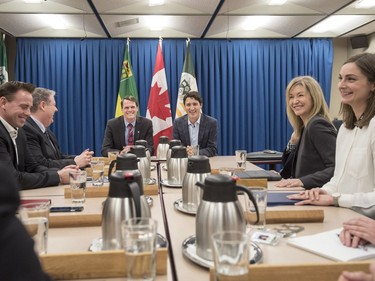 Prime Minister Justin Trudeau (Centre R) speaks with Saskatoon Mayor Charlie Clark (Centre L) and city councillors (L-R) Troy Davies, Randy Donauer, Cynthia Block and Mairin Loewen at City Hall in Saskatoon, January 25, 2017.