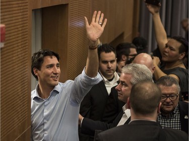 Prime Minister Justin Trudeau waves as he leaves the room after speaking with the public in a lecture hall at the Health Sciences Building on the University of Saskatchewan campus in Saskatoon, January 25, 2017.