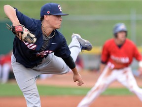 Sean Callegari of the Swift Current Indians (L) pitches during a Western Major Baseball League playoff game against the Regina Red Sox at Currie Field in Regina on August 8, 2014