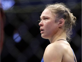 Ronda Rousey stands in the cage after Amanda Nunes forced a stoppage in the first round of their women's bantamweight championship mixed martial arts bout at UFC 207, Friday, Dec. 30, 2016, in Las Vegas.