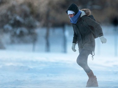 A University of Saskatchewan student runs to make the light during her freezing walk to school Wednesday morning, January 11, 2017.