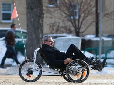 A cyclist travels downtown in his three-wheeled recumbent bike in Saskatoon on January 16, 2017.